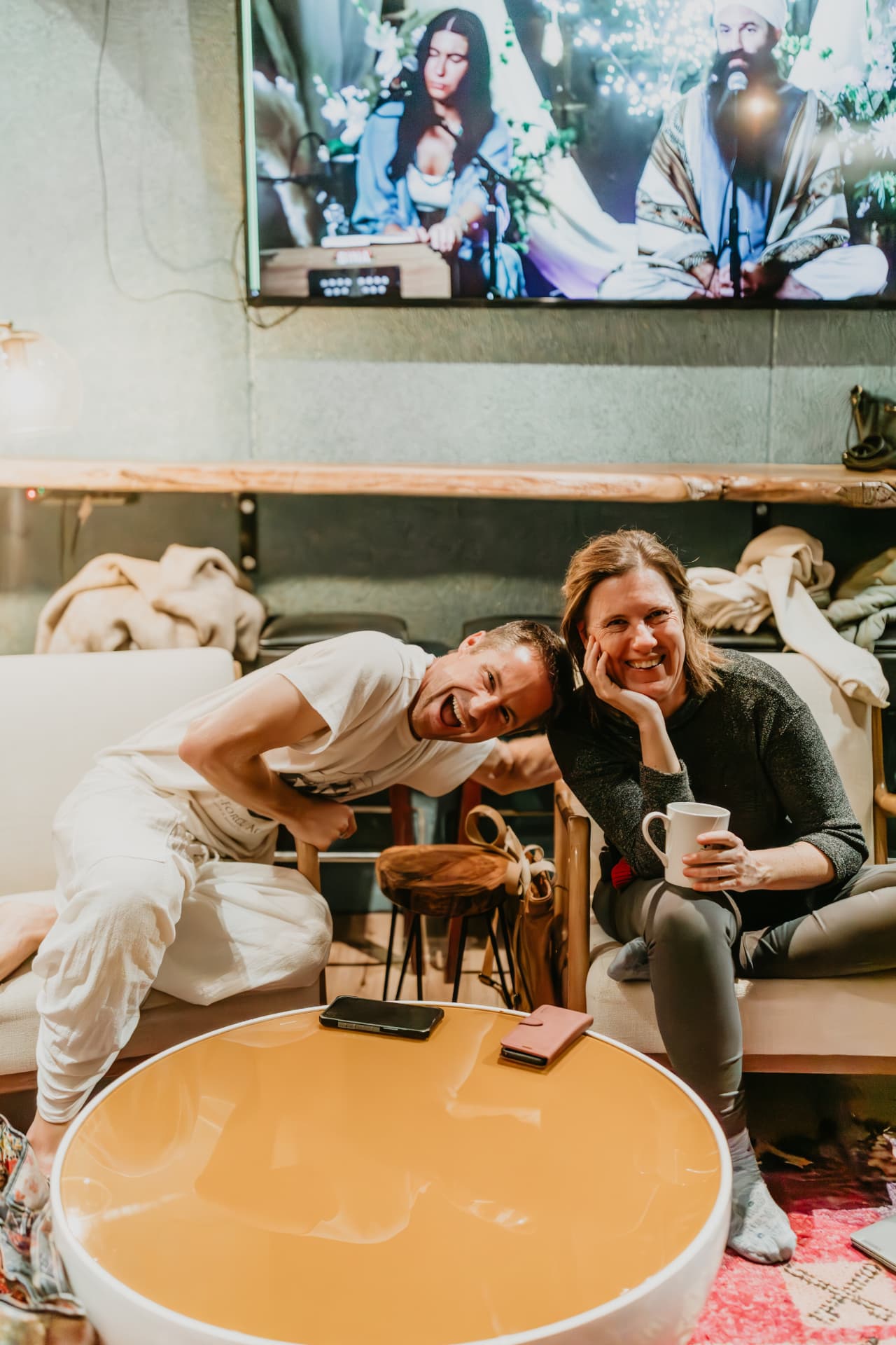 Two participants laughing together in the studio lounge